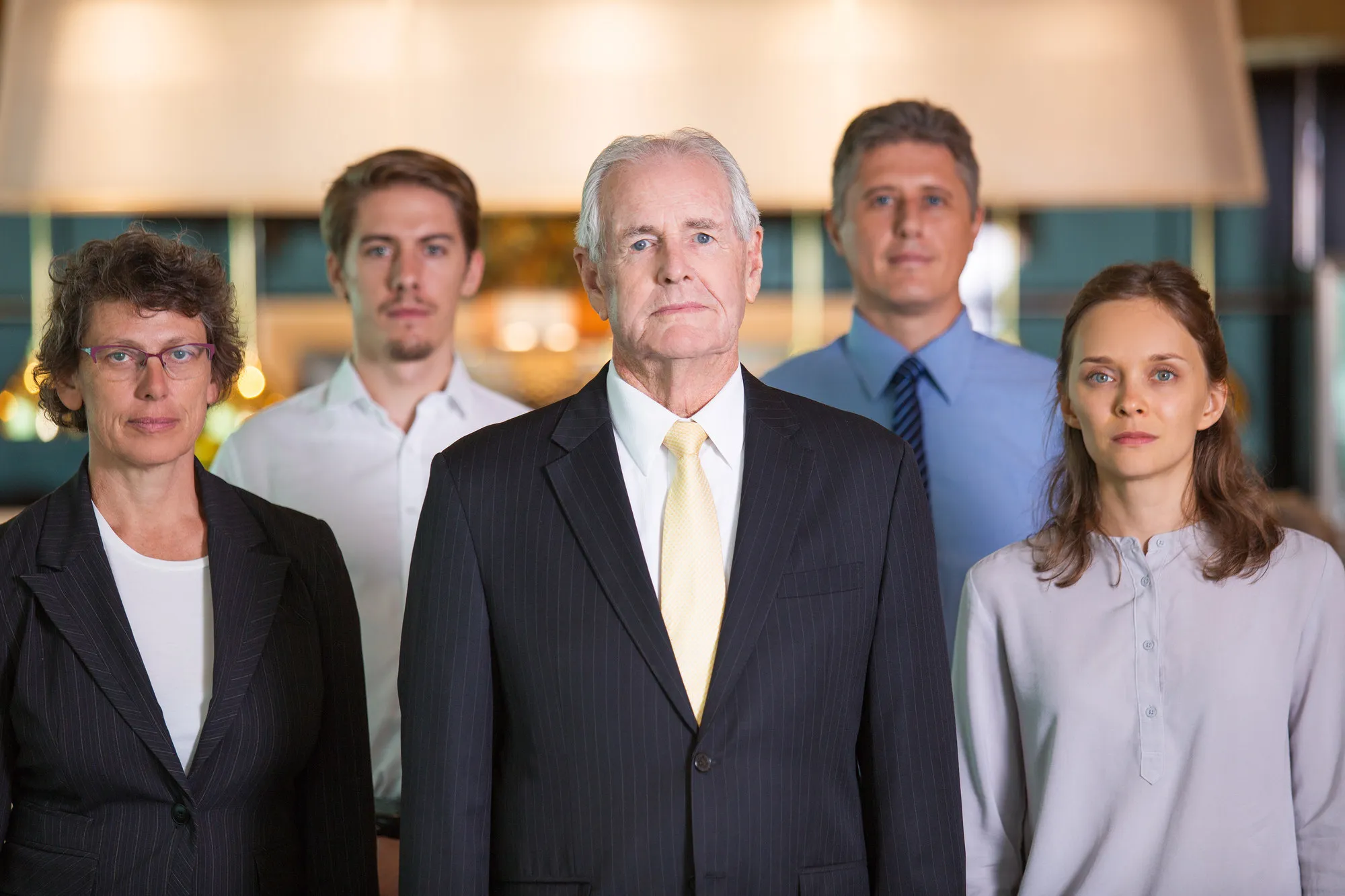 Group portrait of five professionals of different ages