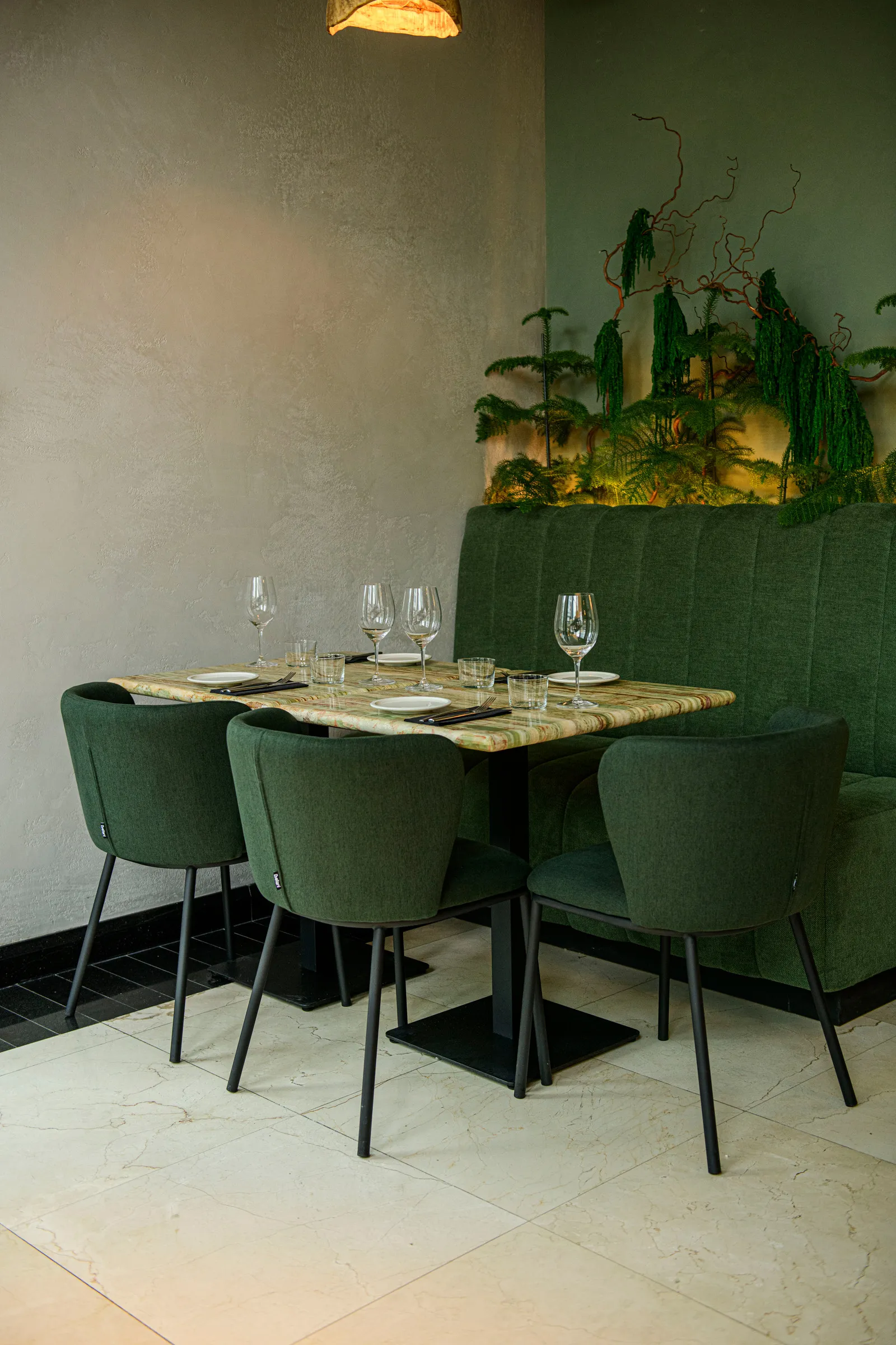 Table for four with green chairs on the ground floor